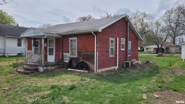 exterior space with a front lawn and central AC unit