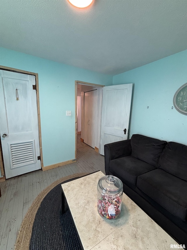 205 N Bentley St, Marion, IL 62959 - living room featuring baseboards, visible vents, hardwood / wood-style flooring, and a textured ceiling