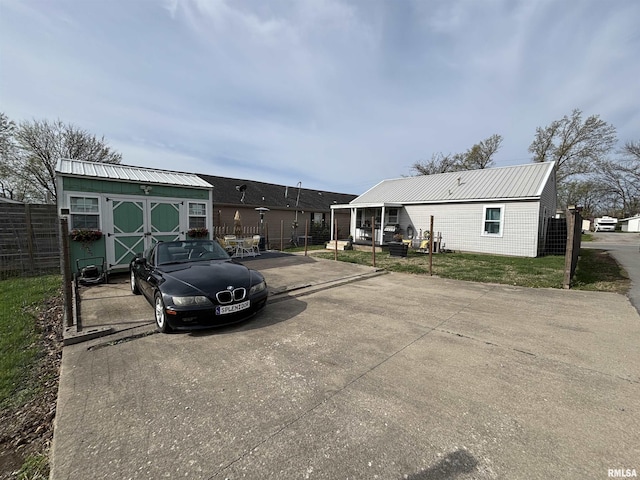 205 N Bentley St, Marion, IL 62959 - view of vehicle parking featuring fence, concrete driveway, and a shed