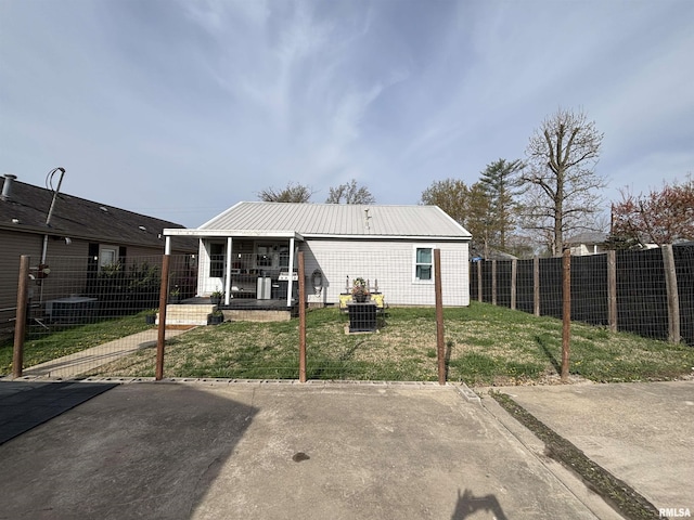 205 N Bentley St, Marion, IL 62959 - rear view of house with metal roof, fence, and a lawn