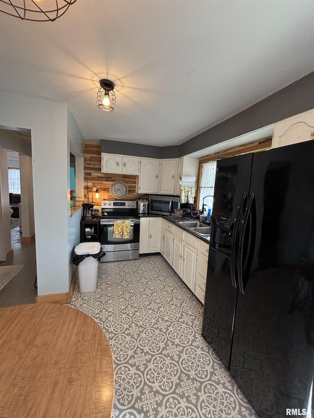 205 N Bentley St, Marion, IL 62959 - kitchen featuring a sink, appliances with stainless steel finishes, baseboards, dark countertops, and white cabinets