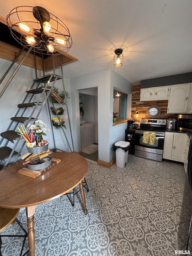 205 N Bentley St, Marion, IL 62959 - dining space featuring baseboards, wooden walls, washing machine and clothes dryer, and a chandelier