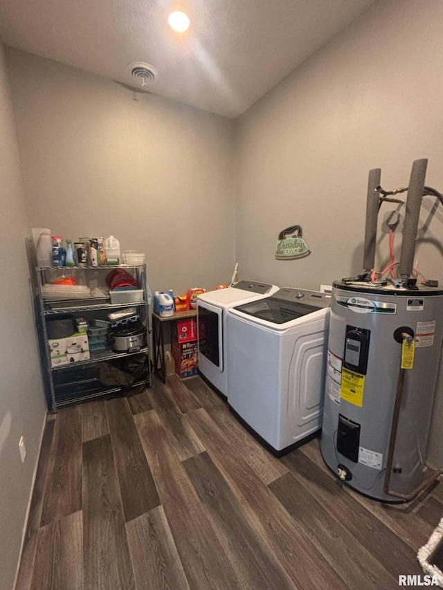 17116 Old Town Dr, Sesser, IL 62884 - washroom with water heater, dark wood-style floors, laundry area, visible vents, and washing machine and dryer