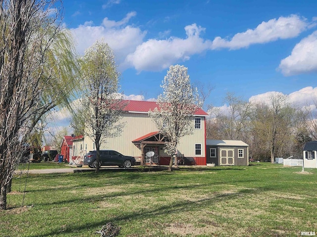 17116 Old Town Dr, Sesser, IL 62884 - rear view of property featuring an outdoor structure, a yard, a shed, and metal roof