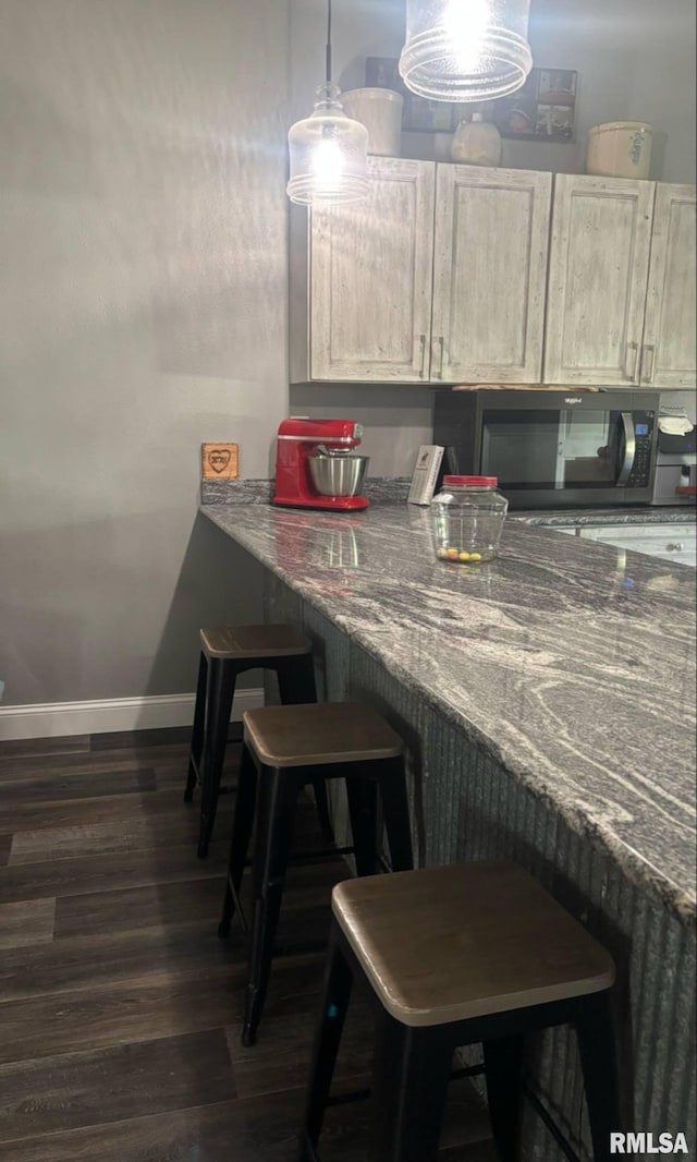 17116 Old Town Dr, Sesser, IL 62884 - bar featuring baseboards, hanging light fixtures, and dark wood-style flooring