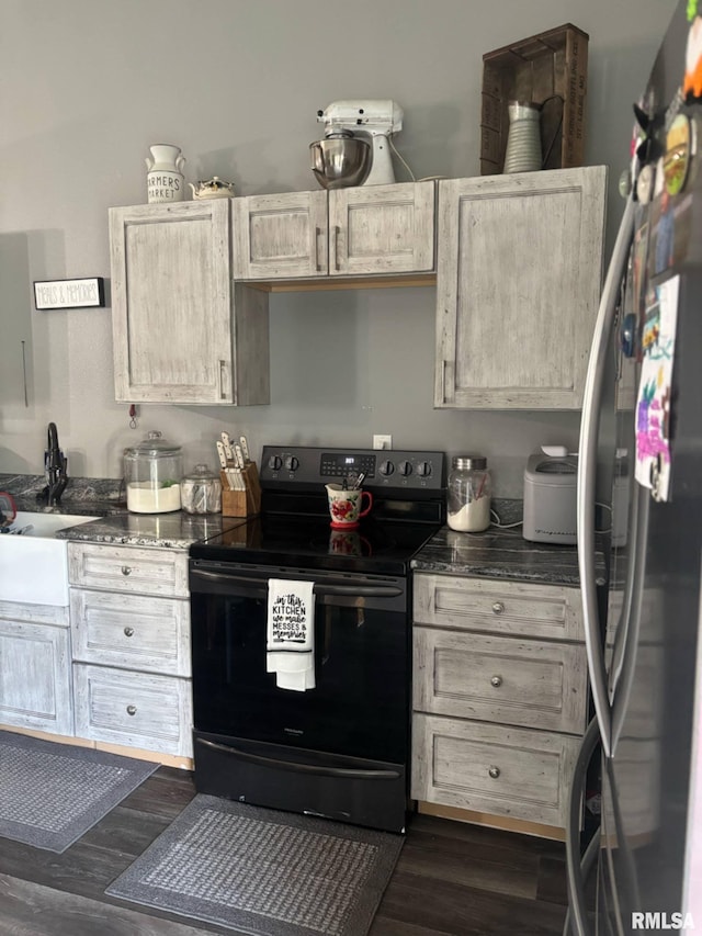 17116 Old Town Dr, Sesser, IL 62884 - kitchen featuring dark wood finished floors, freestanding refrigerator, black range with electric stovetop, and a sink