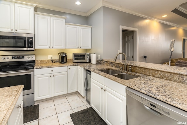 kitchen featuring a sink, light tile patterned floors, ornamental molding, and stainless steel appliances