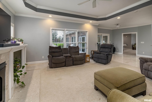 carpeted living room with baseboards, a raised ceiling, recessed lighting, and a fireplace