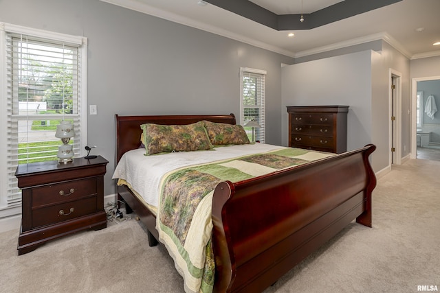 bedroom with crown molding, ensuite bathroom, carpet, a tray ceiling, and baseboards