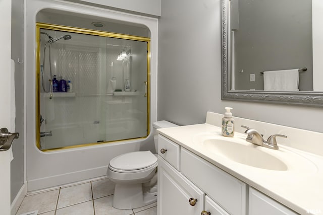 bathroom with bath / shower combo with glass door, toilet, tile patterned flooring, and vanity