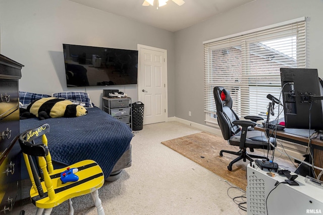 carpeted bedroom featuring baseboards and ceiling fan