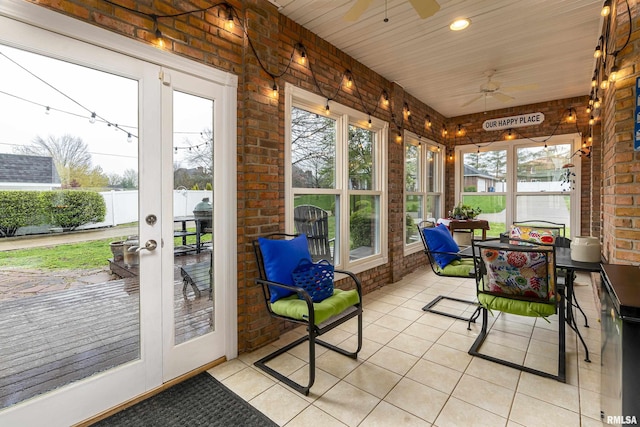 sunroom / solarium featuring outdoor dining space and a ceiling fan
