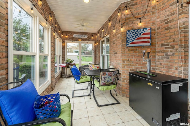 sunroom / solarium with a ceiling fan