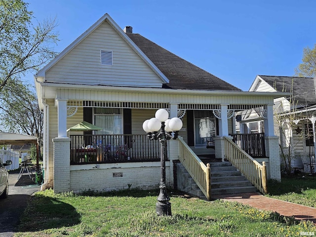 107 W Lincoln St, Harrisburg, IL 62946 - view of front facade with a chimney, covered porch, and roof with shingles