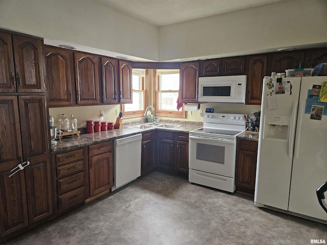 107 W Lincoln St, Harrisburg, IL 62946 - kitchen with a sink, dark brown cabinets, dark countertops, and white appliances