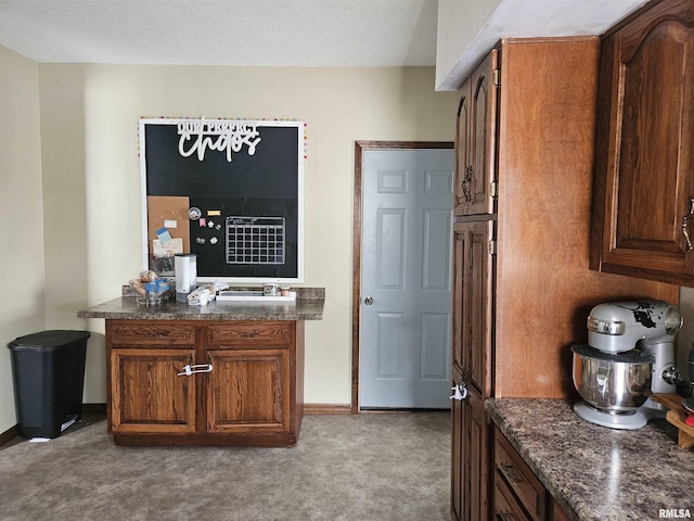 107 W Lincoln St, Harrisburg, IL 62946 - kitchen with baseboards, a textured ceiling, and carpet floors