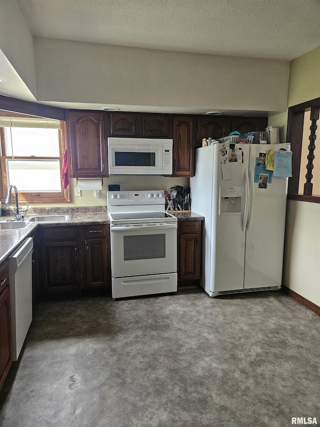 107 W Lincoln St, Harrisburg, IL 62946 - kitchen with baseboards, white appliances, a textured ceiling, dark brown cabinets, and a sink