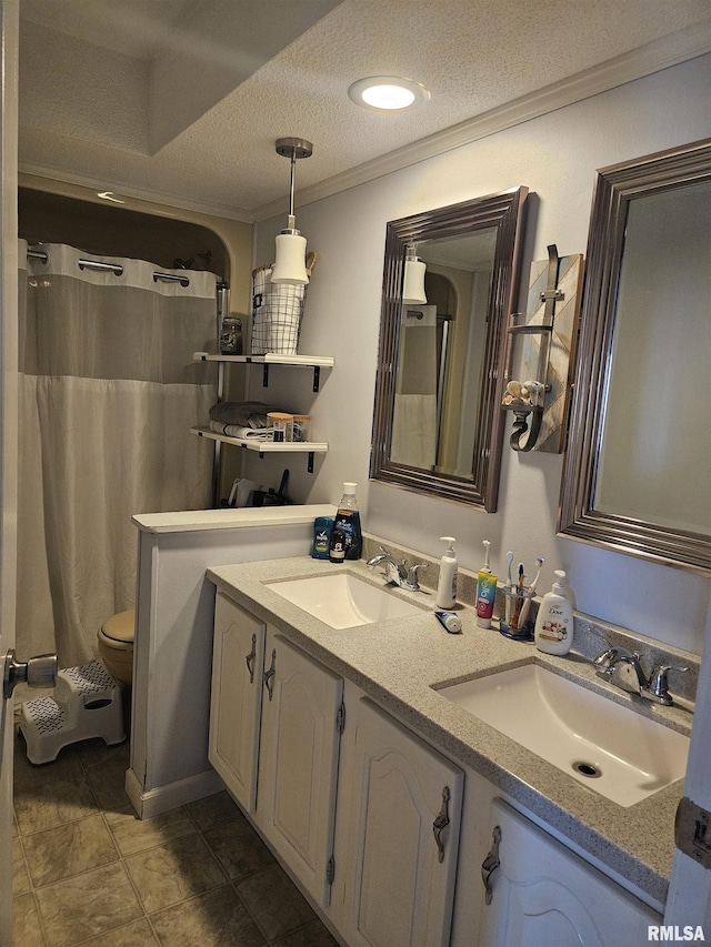 107 W Lincoln St, Harrisburg, IL 62946 - bathroom with a sink, double vanity, crown molding, and a textured ceiling