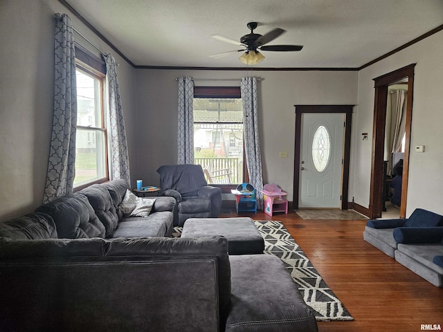 107 W Lincoln St, Harrisburg, IL 62946 - living area with crown molding, ceiling fan, wood finished floors, and baseboards