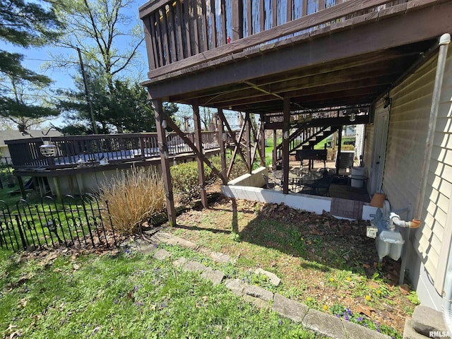 view of yard with stairs and a wooden deck