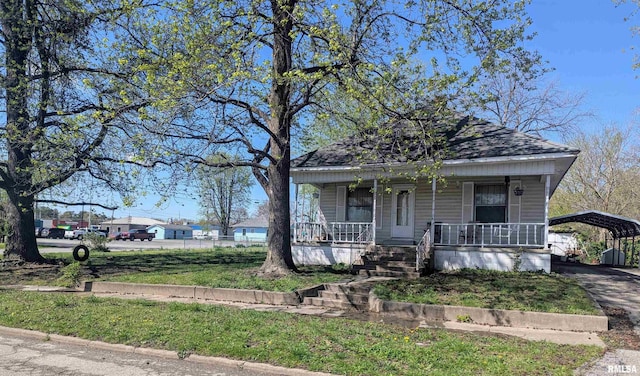 bungalow-style home with a carport and a porch