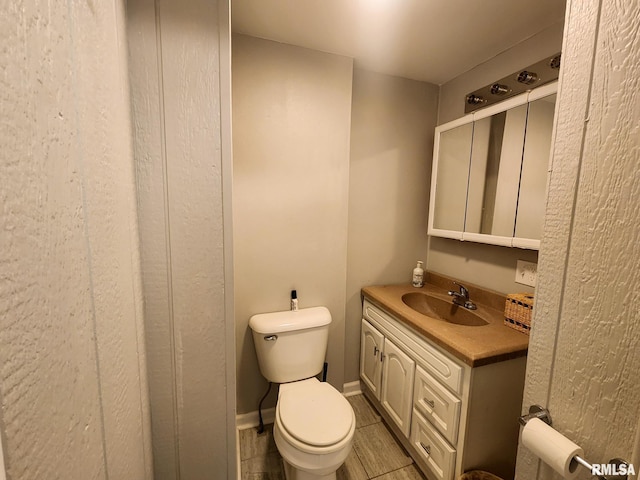 609 S Poplar St, Carbondale, IL 62901 - half bathroom with vanity, baseboards, and toilet