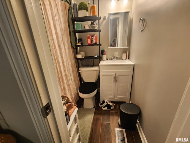 609 S Poplar St, Carbondale, IL 62901 - full bath with toilet, wood finished floors, and vanity