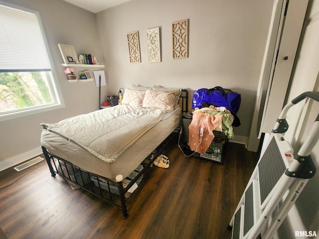 609 S Poplar St, Carbondale, IL 62901 - bedroom with visible vents, baseboards, and wood finished floors
