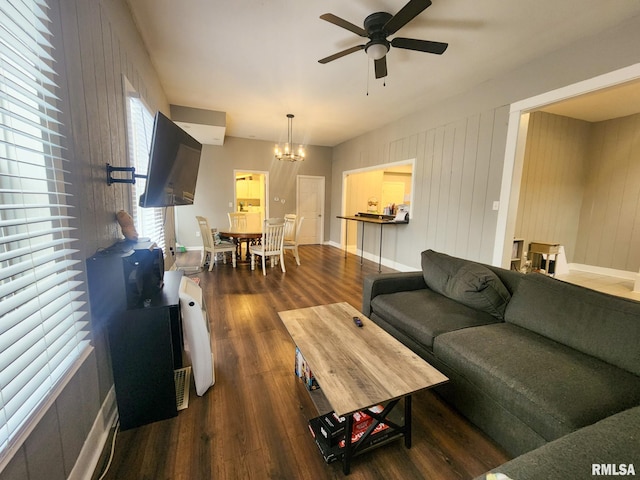 609 S Poplar St, Carbondale, IL 62901 - living room with wood finished floors, ceiling fan with notable chandelier, and baseboards