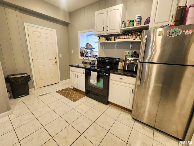 609 S Poplar St, Carbondale, IL 62901 - kitchen with open shelves, freestanding refrigerator, black electric range oven, dark countertops, and white cabinetry
