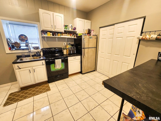 609 S Poplar St, Carbondale, IL 62901 - kitchen featuring freestanding refrigerator, open shelves, dark countertops, black electric range, and a sink