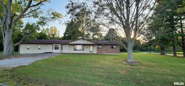 single story home with aphalt driveway and a front yard