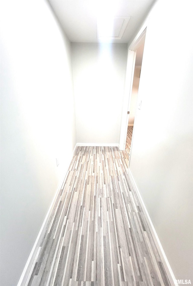 spare room with wood finished floors and baseboards