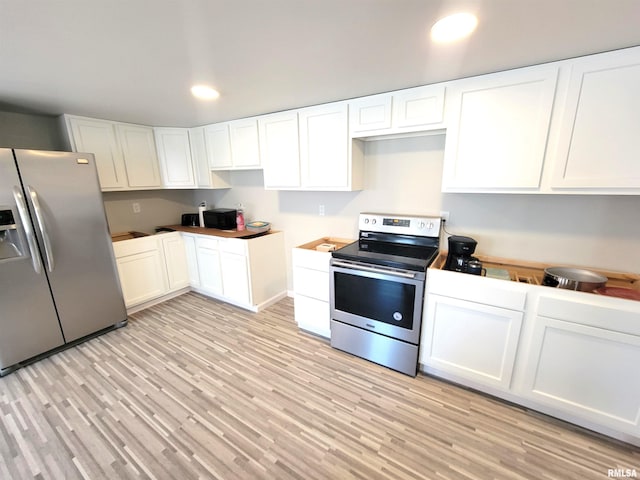 kitchen with stainless steel appliances, recessed lighting, light wood-style floors, and white cabinets