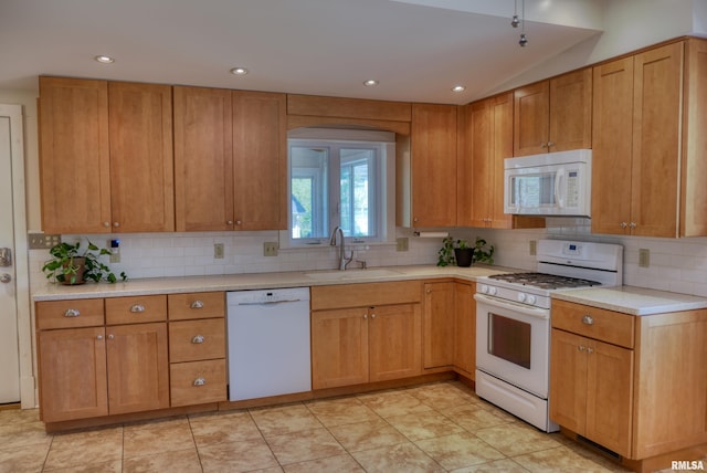 kitchen with a sink, light countertops, white appliances, recessed lighting, and decorative backsplash
