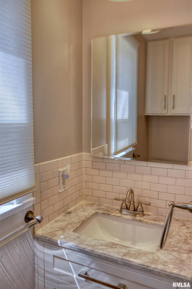 bathroom featuring tasteful backsplash and vanity