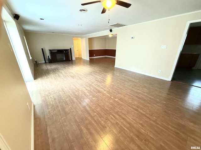 unfurnished living room with visible vents, wood finished floors, and ceiling fan