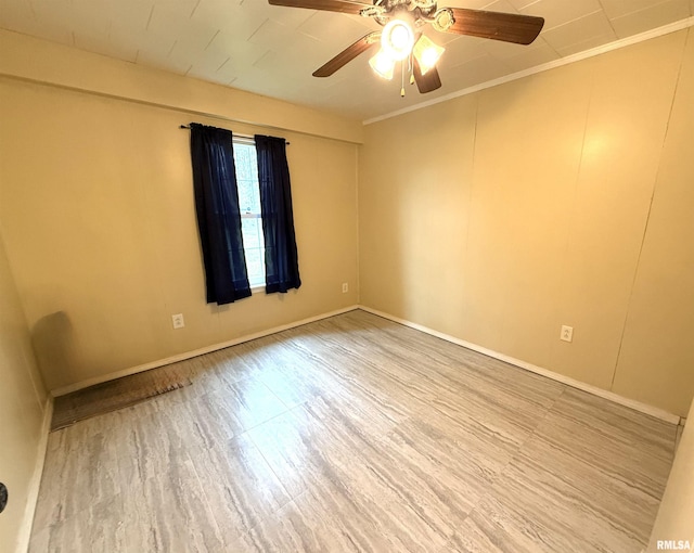 unfurnished room featuring ceiling fan, baseboards, and wood finished floors