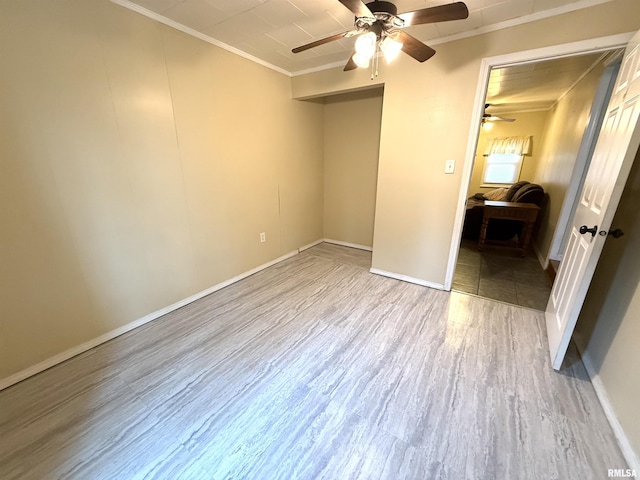 unfurnished bedroom with baseboards, ornamental molding, a ceiling fan, and wood finished floors