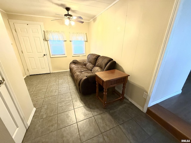 tiled living area featuring baseboards, crown molding, and ceiling fan