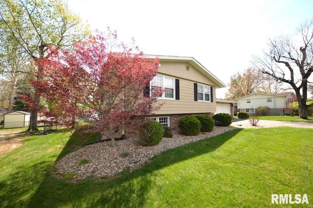 view of home's exterior with a garage and a lawn