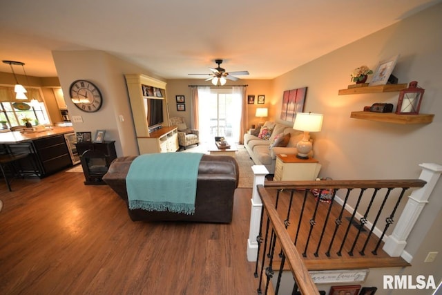 living room featuring plenty of natural light, a ceiling fan, and wood finished floors