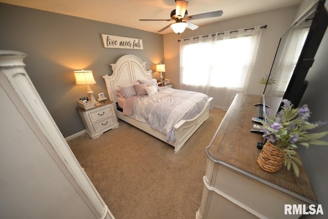 bedroom featuring light carpet and a ceiling fan