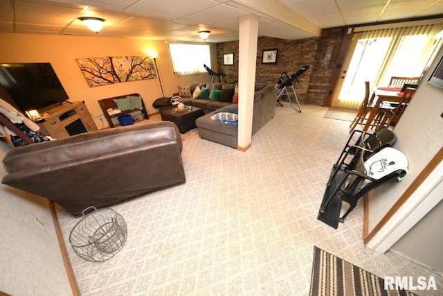 living room featuring a wealth of natural light, a paneled ceiling, baseboards, and carpet floors