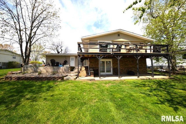 back of property with a yard, french doors, a deck, and a patio area