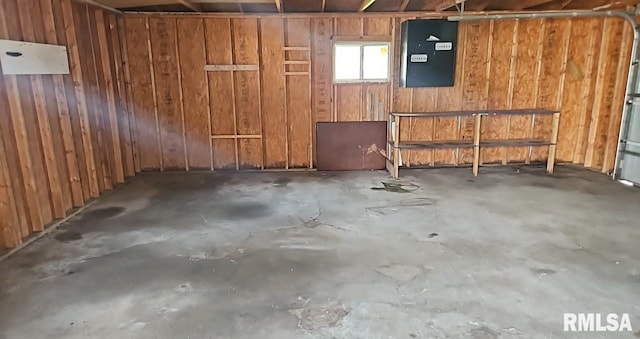 318 W Raymond St, Harrisburg, IL 62946 - below grade area featuring wood walls, a garage, and electric panel