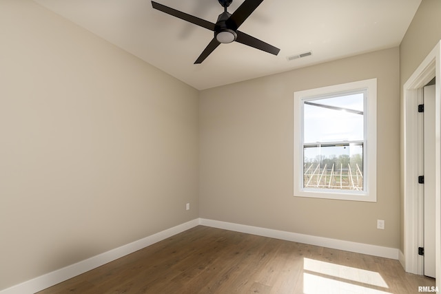 unfurnished bedroom with visible vents, baseboards, a ceiling fan, and wood finished floors
