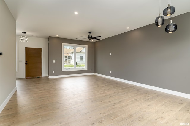 unfurnished living room featuring light wood-style flooring, baseboards, a ceiling fan, and recessed lighting