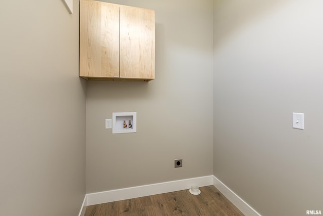 laundry area featuring electric dryer hookup, baseboards, washer hookup, cabinet space, and wood finished floors