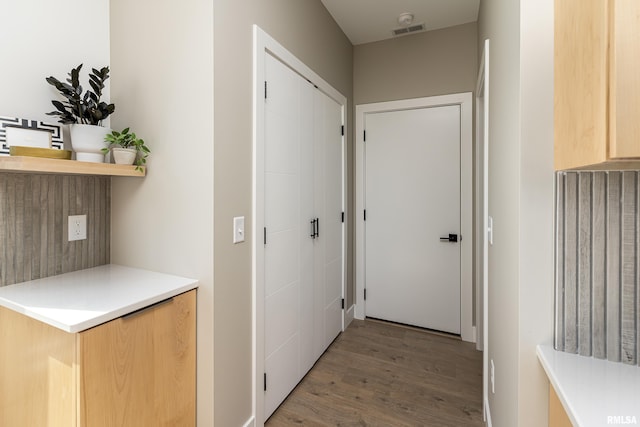 hall featuring light wood-style floors and visible vents